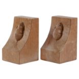 A pair of Robert 'Mouseman' Thompson oak bookends, of adzed, wedge shape with carved mouse '