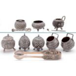 Six Indian silver repousse globular condiment pots, Kutch, c1900, two other items, two salt spoons
