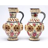 A pair of Fischer double walled, reticulated ewers, late 19th c, the tongue form handle issuing from