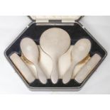 A George V six piece silver brush set, engine turned, mirror 27cm l, by Hasset & Harper Ltd,