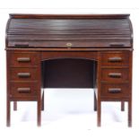 A Lebus stained oak desk with tambour shutter, early 20th c, 107cm h; 68 x 122cm Wear and