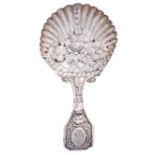 A George III silver caddy spoon, the die stamped shell shaped bowl with flowers and basket work,