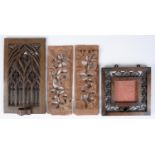 A gothic style carved wood mirror, with candle sconce, 40cm h, a carved wood picture frame and