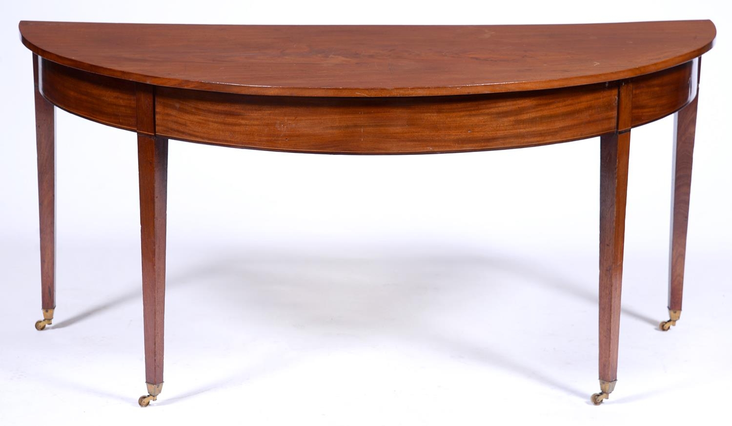 A George III mahogany side table, originally one end of a dining table, with flame figured top, on
