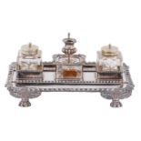 A Victorian EPNS inkstand, in Regency style, with taperstick and pair of cut glass inkwells,