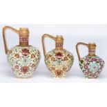 Three Fischer ewers, late 19th c, of similar form, decorated in Iznik style, the neck and handle