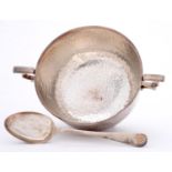 A George V silver porringer and spoon, hammer textured, porringer 15.5cm over handles, by James