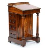 A Victorian rosewood davenport,  with three quarter gallery, the lid inset with gilt tooled red