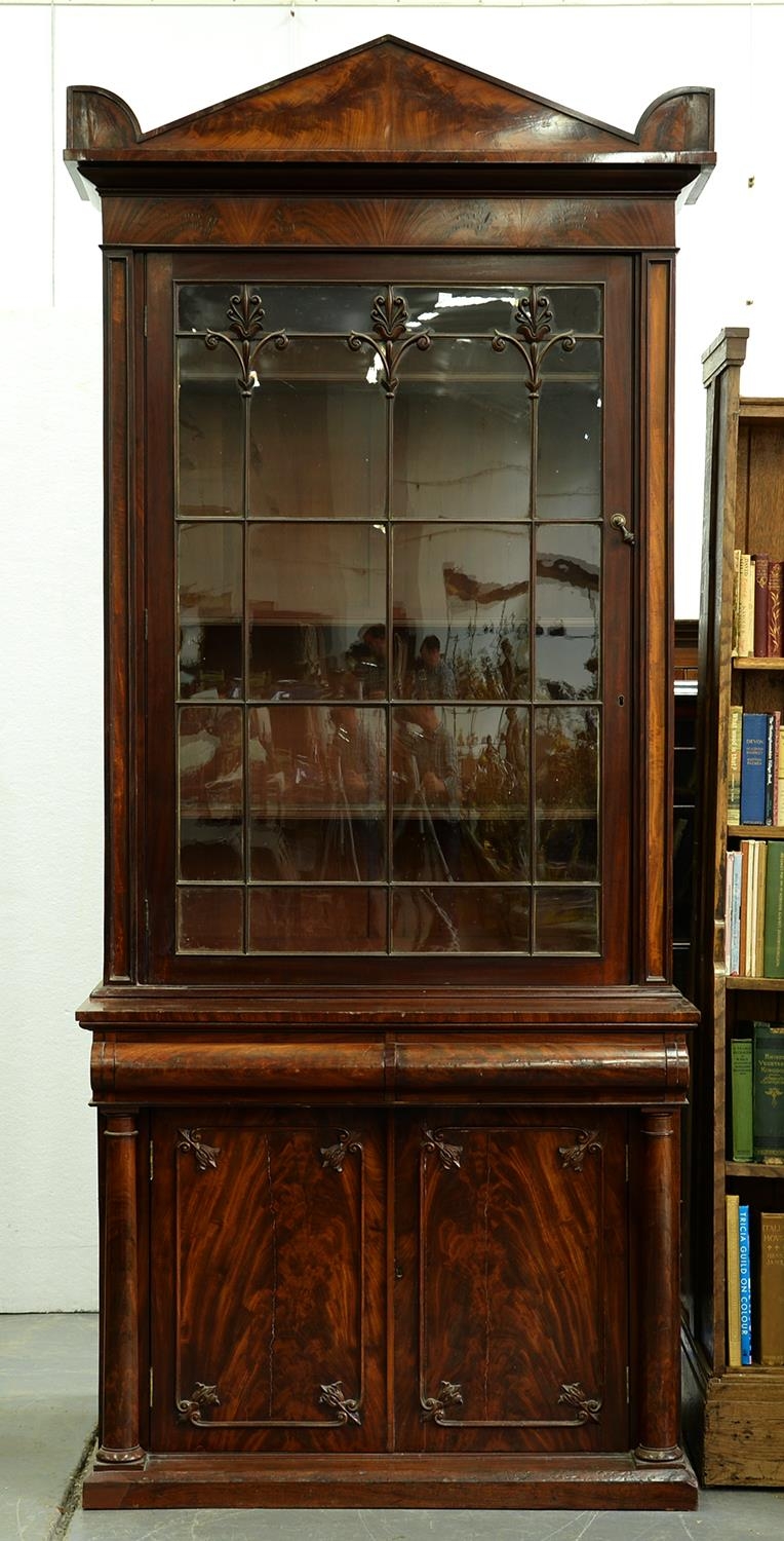 A William IV mahogany bookcase, the figured pediment with acroteria above similarly figured