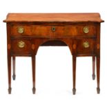 A George III serpentine mahogany dressing table, with broken line inlay and oval paterae, the drawer