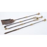 A set of three Victorian brass mounted and burnished steel fire irons, shovel 72cm l Old rust