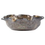A Burmese silver repousse bowl, early 20th c, with eight-lipped rim, chased with continuous jungle