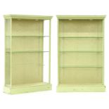 A pair of painted wood cabinets, 20th c, in George III style, with adjustable plate glass shelves,