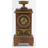 A French ormolu mounted mahogany mantel clock, 19th c, of pillar shape, surmounted by an urn and