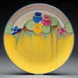 Clarice Cliff. An A J Wilkinson Pansies wall plaque, 1932, 33.5cm diam, printed mark Good condition,