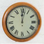 A light oak wall timepiece, c1900, with painted dial and simple barrel movement, pendulum, 38cm diam