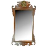 A parcel gilt mahogany fretted frame mirror, 19th c, 87 x 46cm Cresting repaired where broken