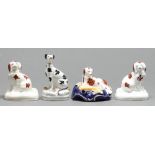 Four Staffordshire earthenware models of dogs, mid 19th c, including a quill holder in the form of a