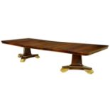 A parcel gilt mahogany twin pillar dining table in Regency style, by R & D Davidson, London, the
