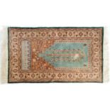 A Turkish art silk prayer rug, 157 x 91cm and a Chinese Batou-Suiyan rug, 157 x 91cm (2)