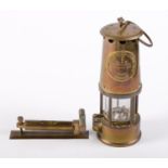 A brass spirit level and a miner's safety lamp by the Protector Lamp & Lighting Co Good condition