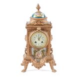 A French porcelain mounted spelter gilt mantel clock, the primrose enamel dial decorated with swags,