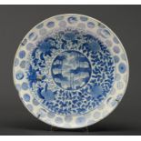 A Japanese blue and white dish, Seto, Meiji period, painted to the centre with a bamboo grove