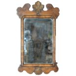 A parcel gilt walnut mirror, early 20th c, the fretted cresting applied with a gilt scallop shell,