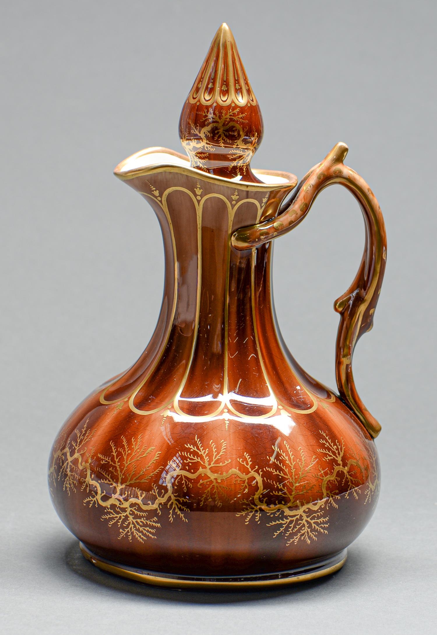 A Rockingham decorated brown glazed and gilt ale jug and stopper, Isaac and Alfred Baguley, c1842-