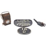 A cast iron plate, 1934 Darlington, No 173860 and a cast iron 16/D, a painted tinplate lamp and a