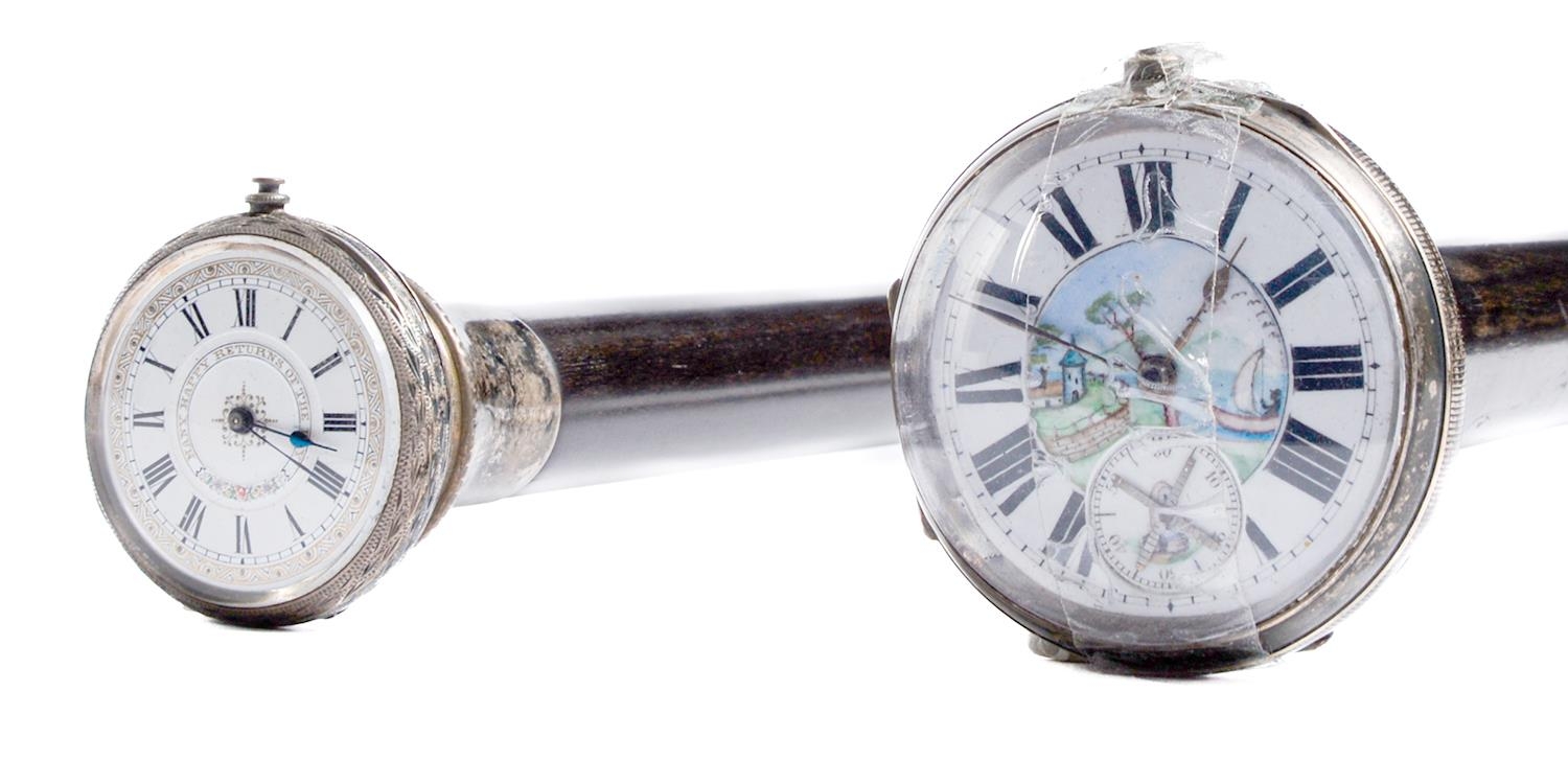 A silver mounted ebony gadget cane, the pommel incorporating a silver watch with enamel dial, horn