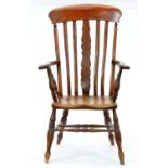 A Victorian red-stained ash kitchen chair One arm loose; slightly scratched, retaining