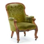 A Victorian mahogany armchair, on castors Splits in back and wear, buttoned green upholstery faded
