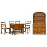 An oak canopied dresser, with linen fold panels, a set of six ladder back dining chairs and a