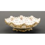 A pierced majolica dish, probably Hungarian, c1900, decorated with flowers, the exterior in olive