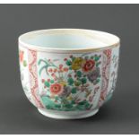 A Chinese famille verte bowl, Qing dynasty, 19th c,  painted with four panels of flowering plants,