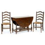 A pair of rush seated stained ash ladder back chairs and an oak gateleg table on spiral legs Typical