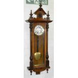 A walnut Vienna clock, early 20th c, pendulum and two brass sleeved weights, approximately 132cm h