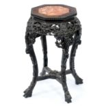 A Chinese hardwood stand, c1900, with octagonal pink stone inset top, 61cm h Dusty but complete,