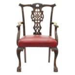 A carved mahogany elbow chair, early 20th c, in George II style Unevenly faded, slight wear