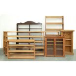 Three similar light wood open bookcases, two others of later date and of pine and another of