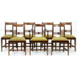 A set of seven Regency mahogany dining chairs, including an elbow chair, with slip seats, seat