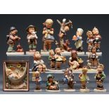 Fifteen Goebel figures of children and a plaque, modelled by M J Hummel, various sizes, printed