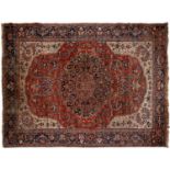An antique red ground rug, 269 x 364cm
