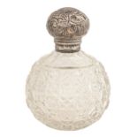 An Edwardian silver mounted cut glass scent bottle, 13.5cm h, with screw cap, marks rubbed,