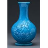 A Chinese kingfisher blue monochrome glazed vase, decorated in relief with prunus, 21cm h