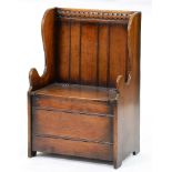 An oak box settle, mid 20th c, in 18th c style, with iron butterfly hinges, 92cm h, seat height