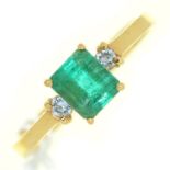 An emerald ring, the step cut emerald flanked by diamonds, in gold marked 18k, 3g, size P