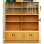 A G-Plan teak bookcase, E Gomme Ltd, c1970, with plate glass sliding doors, 198cm h; 46 x 162cm,