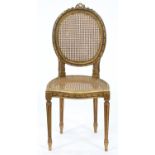 A French giltwood salon chair, early 20th c, in Louis XVI style, caned back and seat, seat height